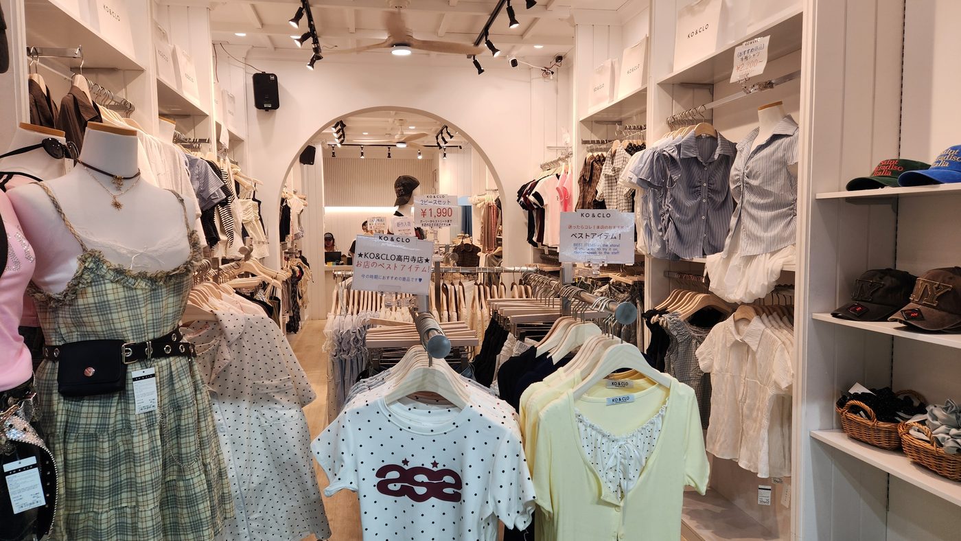 Inside KO&CLO Tokyo — a white arched opening, rails of blouses and printed tees