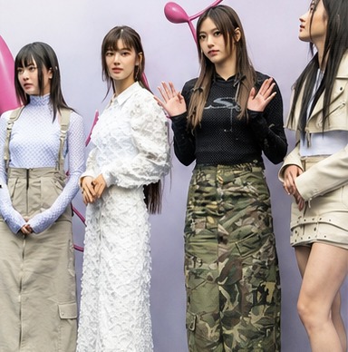 Four women in layered street looks — high-neck knit, cargo and camo